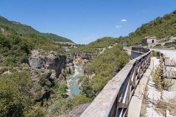 Lapani Bridge, Albania - August 15 2024: Lapani Bridge over the scenic Osumi River Canyon in Albania, blending modern travel with natural beauty