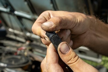 hands of a person working on a car