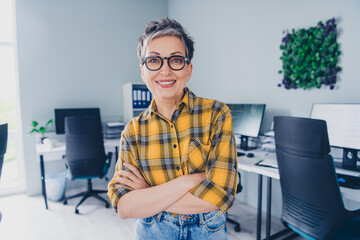 Photo of pretty senior female crossed hands confident wear plaid yellow shirt coworking successful...