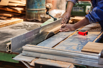 circular saw industrial cutting wood factory african american worker - Powered by Adobe