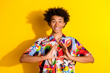 Photo of nice young man show heart symbol wear shirt isolated on bright yellow color background