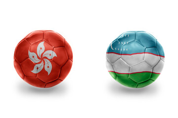 football balls with national flags of uzbekistan and hong kong ,soccer teams. on the white background.