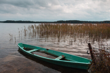 Obraz premium Retro boat in a misty lake. Fog in Shatsky lake, Ukraine. High resolution photo.