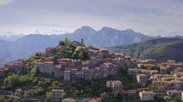 Mountain Village in Liguria: Drone View of Italy&rsquo;s Green Hills and Mountain Panorama on a Bright Day with Blue Sky &ndash; Wide Shot Drone Flyover Tracking Left
