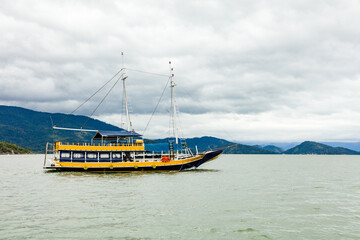 Tourist boat dock in Paraty Bay in Rio de Janeiro, Brazil, where passenger boats await customers to be taken to nearby islands or other villages. world heritage