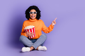 Full length photo of shiny attractive lady dressed knitted pullover watch movie pointing empty space isolated purple color background