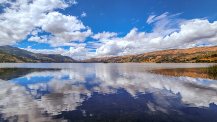 MIRROR LAKE. CLOUDS REFLECTED IN THE WATER. BEAUTIFUL LANDSCAPE OF A LAGOON. PACHUCA LAGOON. PERU TRAVEL.