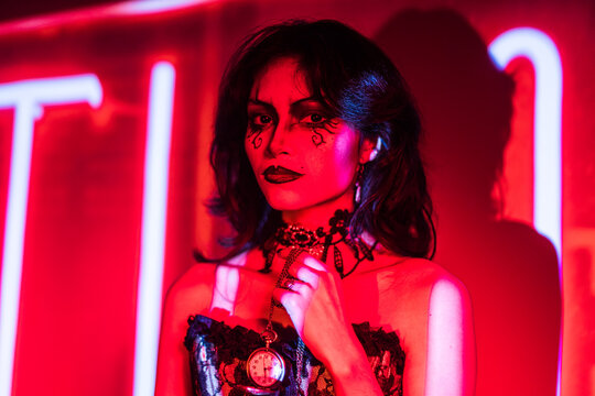Mysterious Gothic Woman with Dramatic Makeup in Red Glow
