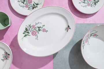 Elegant ceramic tableware in floral design on pastel background