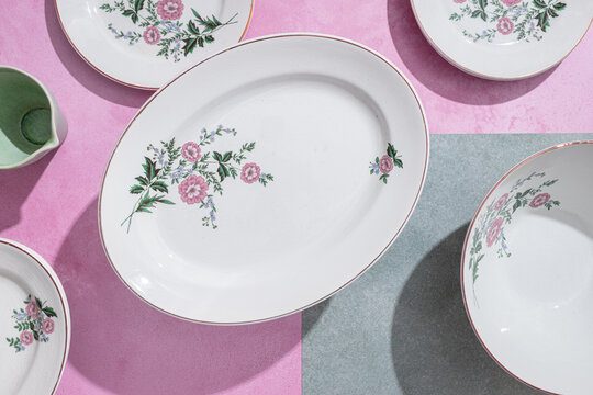 Elegant ceramic tableware in floral design on pastel background