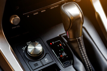 Inside the car.Gear shift handle in a modern car.Vehicle interior.Dashboard, inner workings of a...