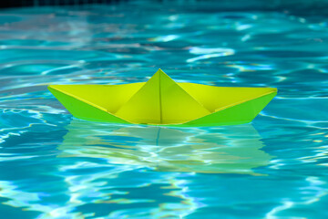 Origami ship boat. Paper boat sailing on water. Paper boat into water. Concept of tourism. Travel vacation holiday. Traveling and sailing adventure.