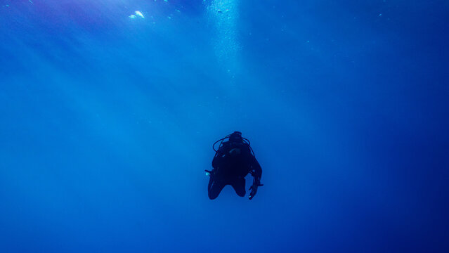 Solitary Scuba Diver in Deep Blue Ocean