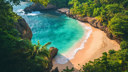 Aerial shot of a beautiful beach with transparent water, soft white sand, and calm waves, framed by vibrant tropical greenery and rocky formations along the shore.