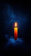 Fototapeta premium Candle flame glowing in dark with smoky background, creating a serene atmosphere.
