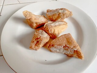 Fried tofu with meat on plate