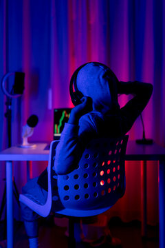 Young male trader monitoring stocks at home setup