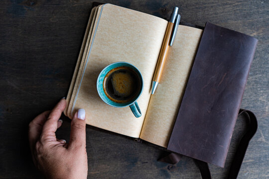Top view of notepad and coffee during work session - Powered by Adobe