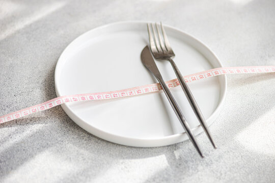 Top view of dieting concept with plate and measuring tape