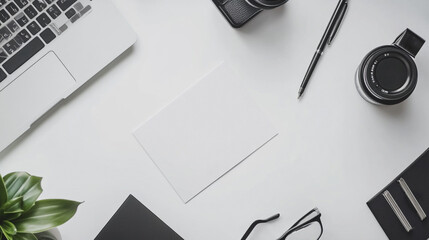 Modern workspace mockup featuring laptop, cameras, and stationery on a clean desktop