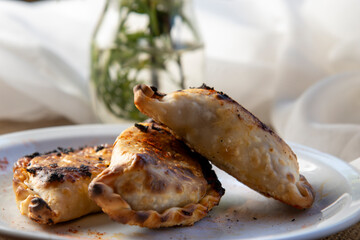 Argentine empanadas on a white plate three