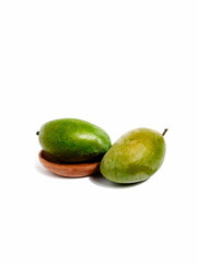 Green Mango on a wooden plate 