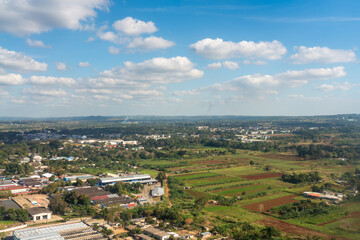 Aerial view of warehouses and houses with fields of crops around a landscape on the outskirts of Havana. Cuba