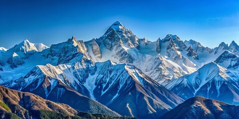 Obraz premium Snow-capped peaks rise against a cerulean sky, their rugged forms casting long shadows across a landscape of frosted slopes and verdant valleys.