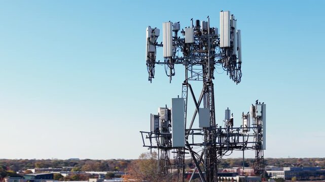 Aerial view of mobile phone cell tower against blue sky