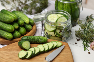 Fresh cucumbers on light table, closeup. Preparation for pickling
