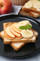 Tasty sandwich with peanut butter, apple, banana and mint on table, closeup