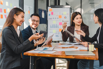 Collaborative business meeting with professionals discussing strategies and data analysis. Engaged team members share ideas and insights in modern office setting