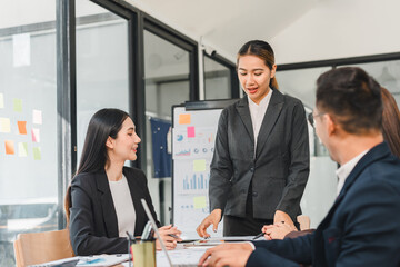 Professional business meeting with woman presenting data to colleagues. atmosphere is focused and collaborative, showcasing teamwork and communication in modern office setting