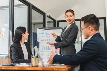 Professional woman presenting marketing report to colleagues in office