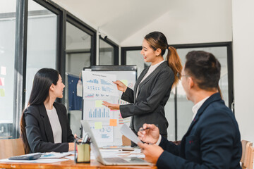 business meeting with woman presenting data charts to colleagues. atmosphere is professional and collaborative, showcasing teamwork and communication