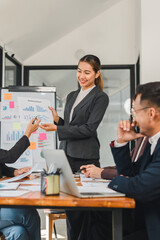 Efficient business meeting with woman presenting marketing report. Team members engaged, discussing strategies and analyzing data