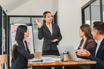 Professional woman presenting in business meeting with colleagues engaged. atmosphere is collaborative and focused on teamwork and communication