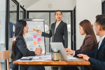 businesswoman presents data to colleagues in modern office setting. team engages with charts and graphs, showcasing collaboration and professionalism