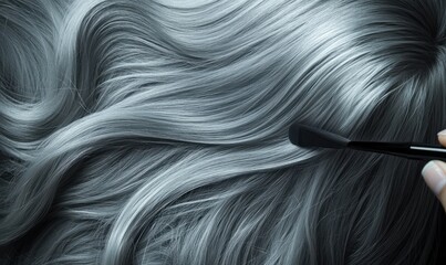 Hair stylist applying dye to gray hair, transforming it into a fresh shade, showing the contrast between natural gray and bold color