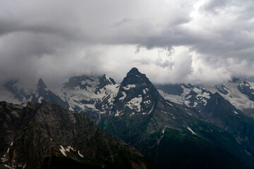 View of the Great Caucasian Ridge opening from the Upper station of the cable car system of the Dombay ski resort on a summer day, Karachay-Cherkessia, Russia