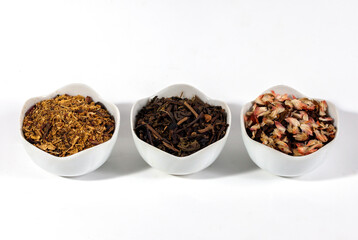 Assortment of dry herbal and berry tea in the little bowl isolated on a white background. Tea party concept. medicinal herbs.