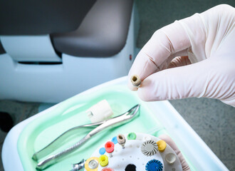 Female dentist holding polishing discs. Resin polishing kit, dental resin polisher, sanding bristle...