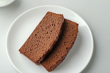 Two slices of chocolate cake on a white plate