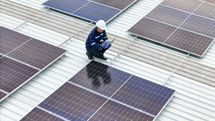 Aerial view of a rooftop with solar panels, showing a technician in safety gear performing maintenance. The scene highlights renewable energy, solar technology, and sustainable infrastructure.