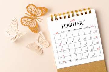 February 2025 desk calendar for the organizer to plan and reminder and butterfly paper on yellow.