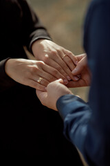 A couple in love touches each other with their hands. Love story of a young couple in love. Wedding...