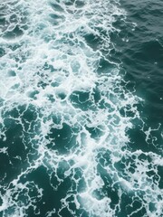 Obraz premium Rough and turbulent ocean waves creating natural texture on the agitated sea surface, surface, texture