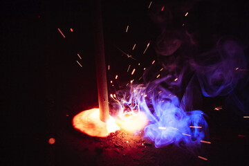 A bright flash of light and a sheaf of sparks in a cloud of smoke. Miniature Universe. Design...