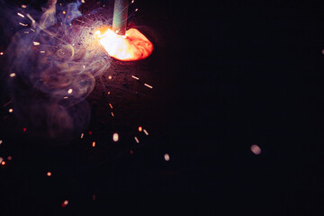 A bright flash of light and a sheaf of sparks in a cloud of smoke. Miniature Universe. Design...