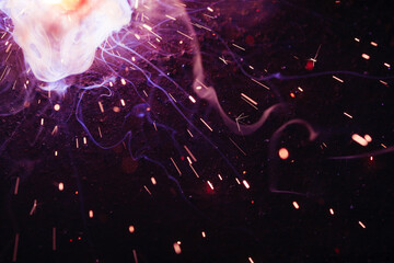 A bright flash of light and a sheaf of sparks in a cloud of smoke. Miniature Universe. Design...